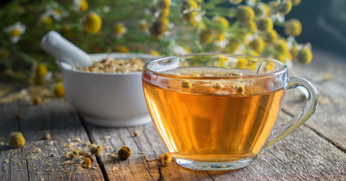 Tazza con infuso di camomilla e capolini essiccati